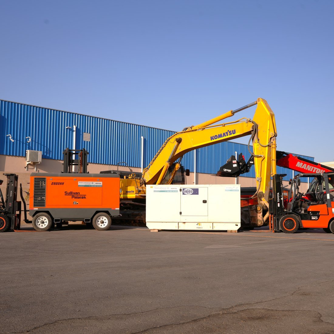Heavy equipment fleet lined up on a contractor's yard